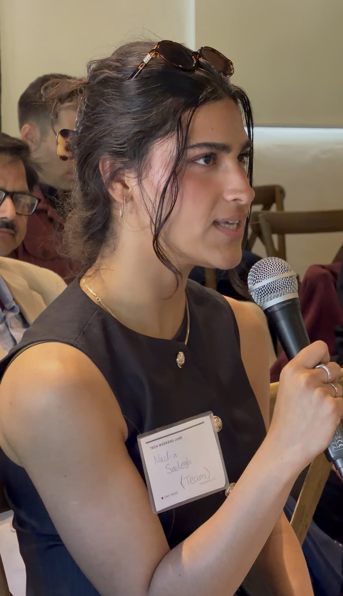 Nadia Sadegh asking a question on the mic at a San Francisco tech event