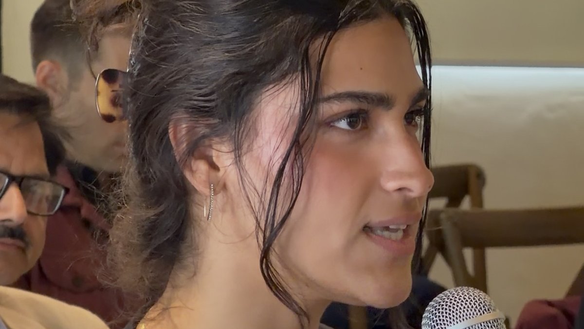 Nadia asking a question with a microphone